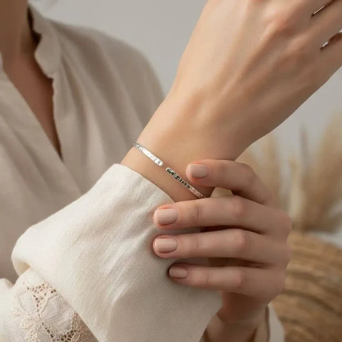 10 Gauge 925 Silver Hammer Textured Bangle worn on wrist with a soft beige blouse.
