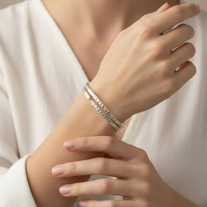 Close-up of a hand wearing a 10 Gauge 925 Silver Hammer Textured Bangle with a stylish outfit.