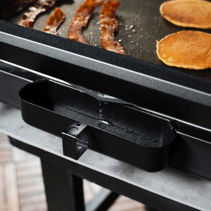The Rear Grease Management System makes cleanup easy, but directly grease and food debris to the back of the griddle into the grease cup.