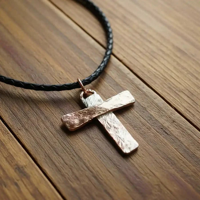 925 Silver Copper Hammer Forged Masculine Cross Necklace on a black braided leather cord, showcasing unique craftsmanship.