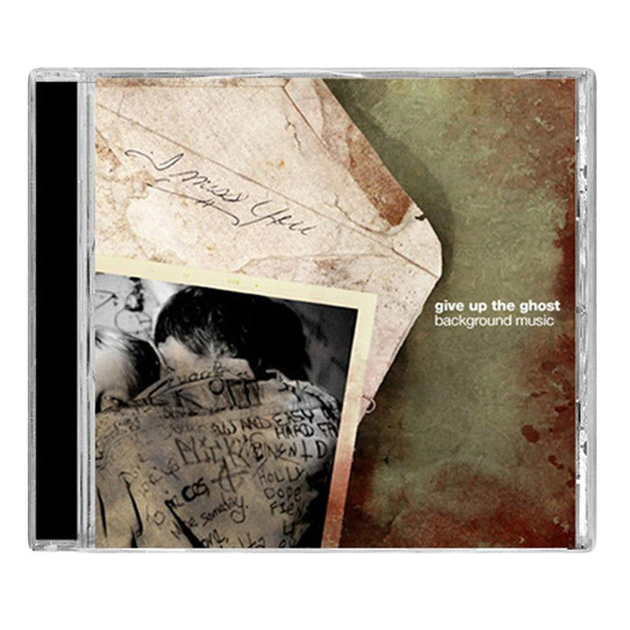 CD cover for Give Up The Ghost’s Background Music, with a faded photo of two people hugging and handwritten notes like “I miss you.” The nostalgic, vintage design captures the raw emotion of hardcore music.