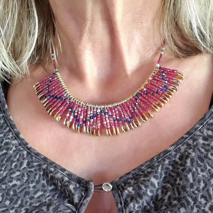 Handmade beaded Swarovski crystal zig zag bib choker necklace showcasing vibrant pink and blue beads on a golden brass chain.