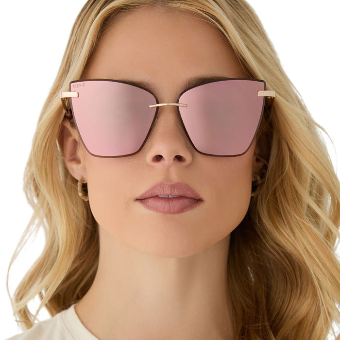 on model - female wearing diff eyewear featuring the becky v cat eye sunglasses with a gold frame and peach mirror lenses front view