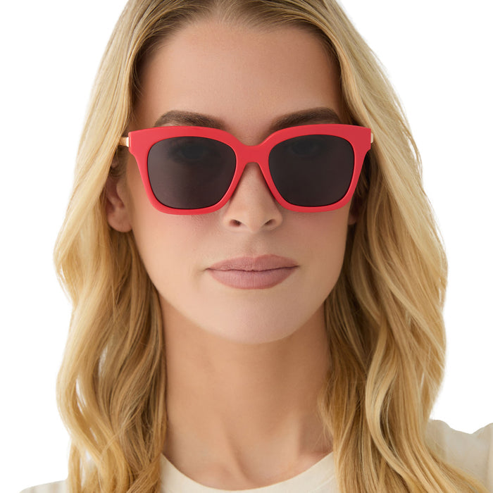 on model - female wearing diff eyewear featuring the bella xs square sunglasses with a sunset bright coral frame and grey lenses front view
