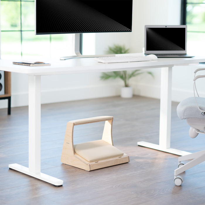 A birch wood footrest with a white cushion on top and storage compartment beneath in a home office setting.