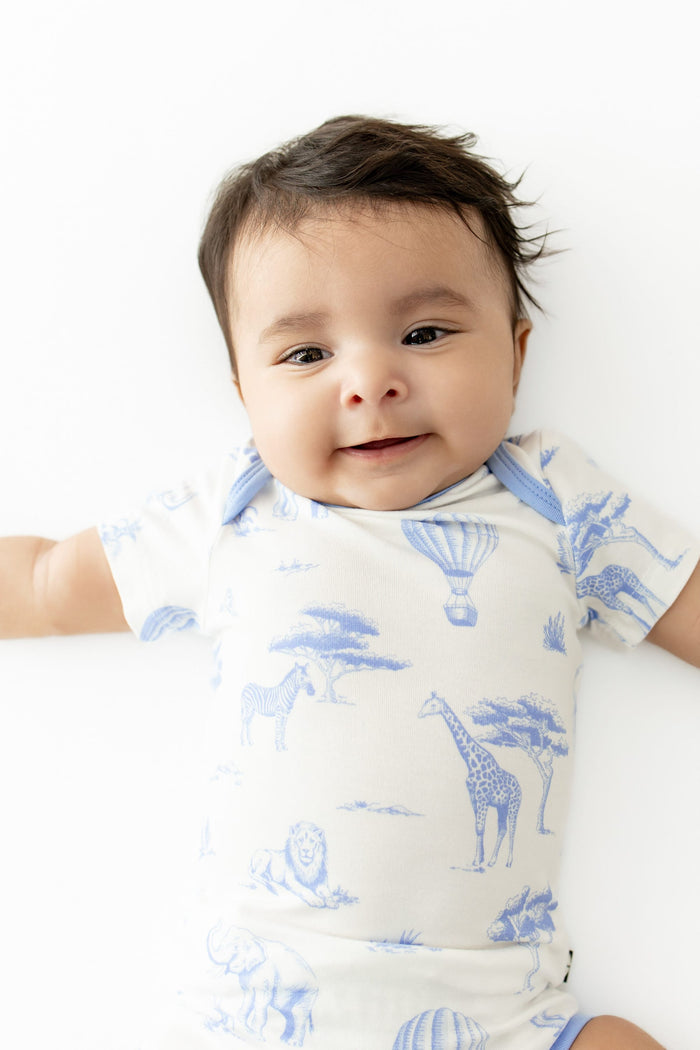 Close up of infant wearing the Bodysuit in Toile Safari