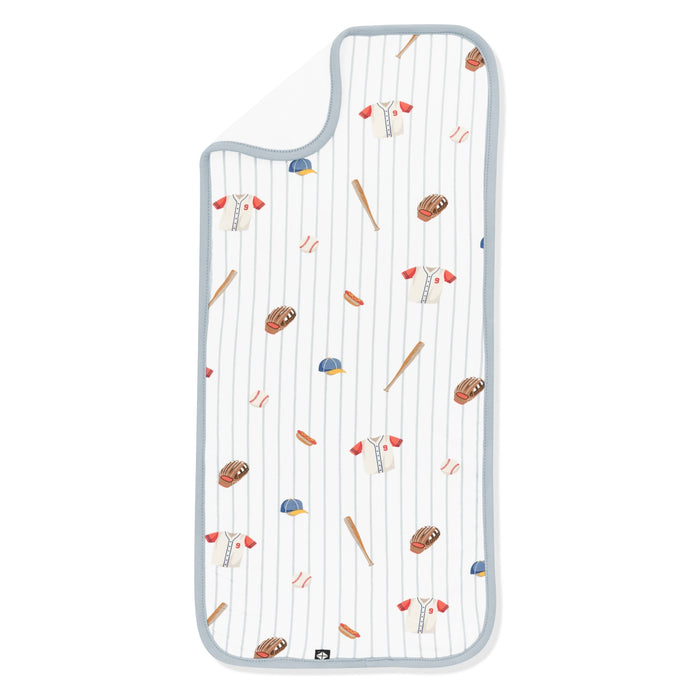 Burp Cloth in Home Run laid flat with the corner flipped down showing the bamboo terry cloth backing