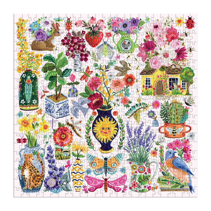 The Buzzy Bouquets 500 Piece Puzzle by Jennifer O Lewis/August Wren features vibrant painted flowers, potted plants, butterflies, birds, a charming house, animals, and patterned vases—an enchanting puzzle for all ages.