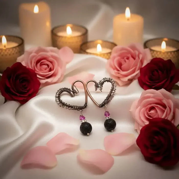 Copper Sculpted Heart Hoop Crystal Lava Rock Earrings with roses and candles in the background