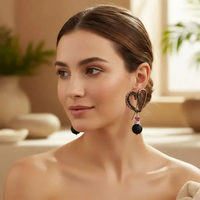 Copper Sculpted Heart Hoop Crystal Lava Rock Earrings worn by a model showcasing their unique design.
