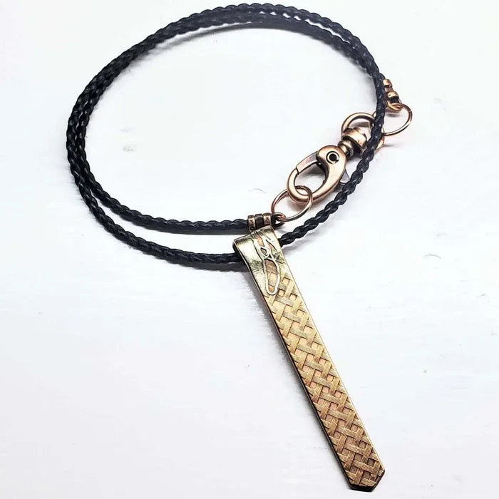 Copper Weave Embossed Necktie Necklace on a braided black cord, showcasing a bold copper pendant.