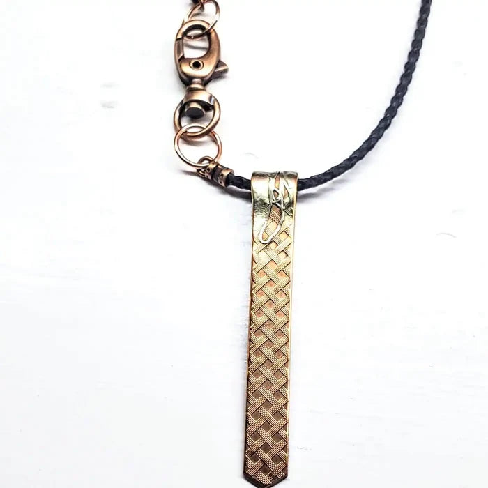 Copper Weave Embossed Necktie Necklace featuring a bold copper pendant and braided strap.