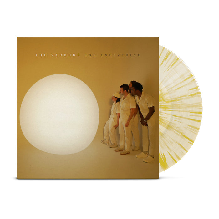 The Vaughns - 'Egg Everything' vinyl. Pictured is a vinyl record against a white background. The album cover is mustard yellow, and it depicts four people in white jumpsuits staring at a large, white orb. Above them are the words "The Vaughns" in white, and "Egg Everything" in black.  There is a vinyl record to the side of the cover. It is a cream color with yellow splatter.