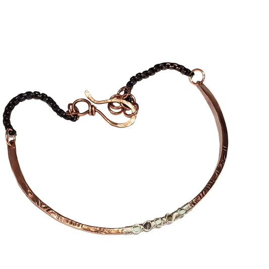Ergonomic Copper Sculpted Embossed Wire Gemstone Choker featuring a unique design with gemstones and a secure clasp.