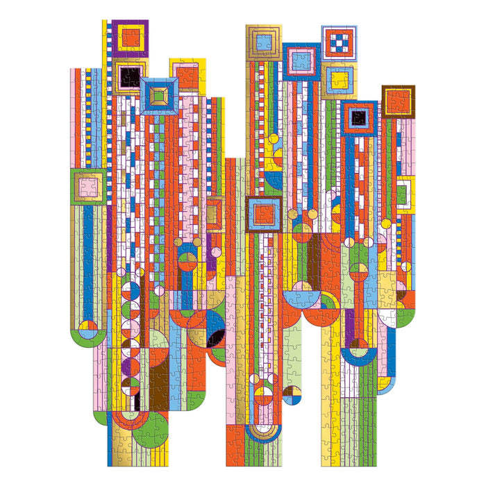 The Frank Lloyd Wright Saguaro Forms & Cactus Flowers 750 Piece Shaped Foil Puzzle by the Frank Lloyd Wright Foundation features vibrant geometric shapes and symmetrical foil accents in red, blue, yellow, orange, and green.