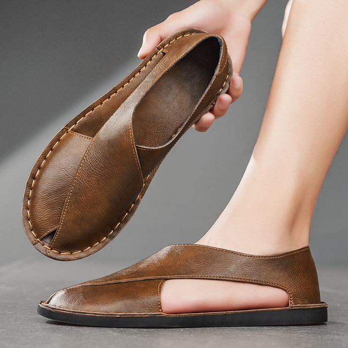 Detailed view of leather stitching on crossover flat sandals