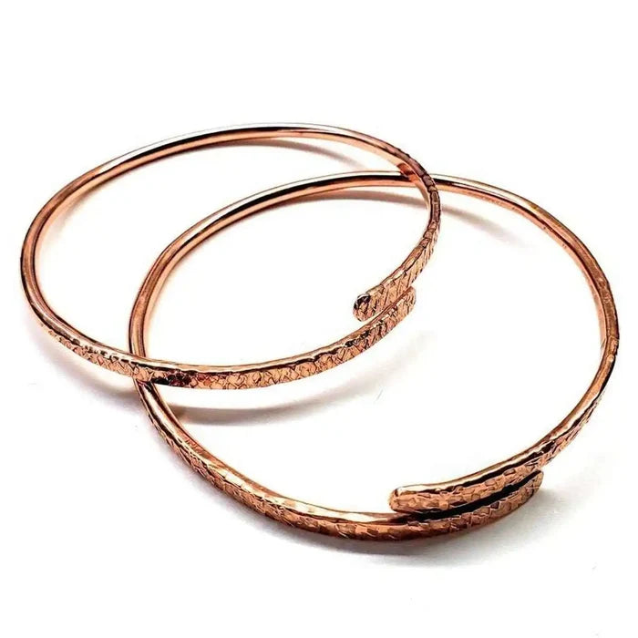 Unisex 8 Gauge Adjustable Hammered Copper Overlap Bangle - Set of two stylish copper bangles on a white background.