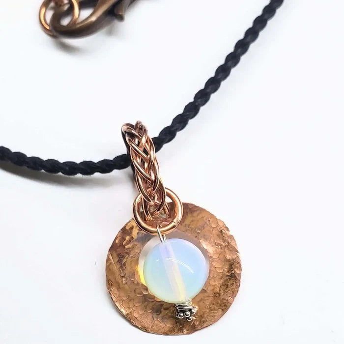 Handmade copper wire braided bail gemstone necklace featuring a rare Luminite gemstone on a braided cord.