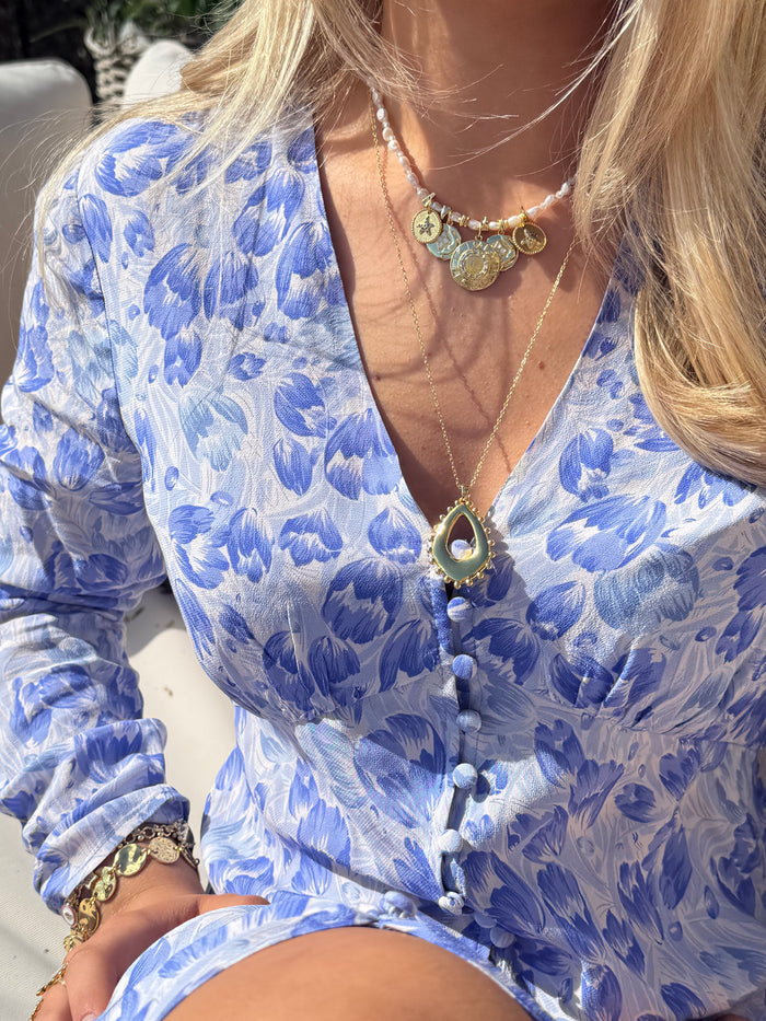 Summer jewellery stack with chunky gold necklaces