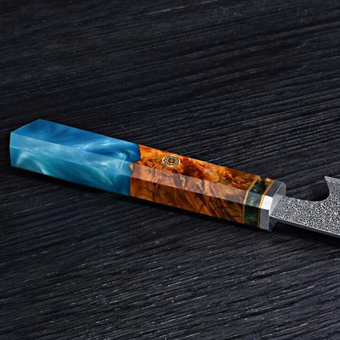 Knife with a blue and brown handle on a dark wooden surface
