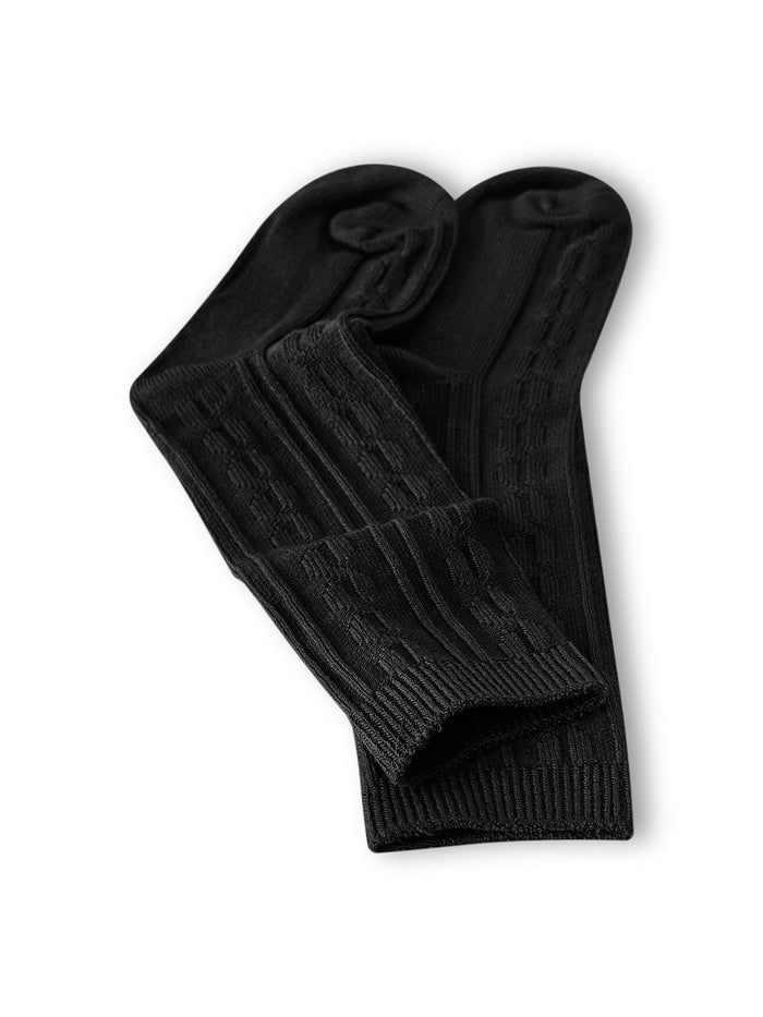 Knee high socks in midnight laying flat on a white background.