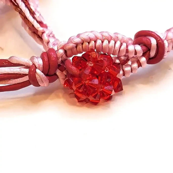 Leather Silk Bead Woven Crystal Button Bracelet showcasing red Swarovski crystal and pink silk weaving.