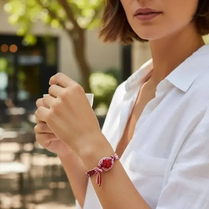 Model wearing a Leather Silk Bead Woven Crystal Button Bracelet outdoors with a casual outfit.