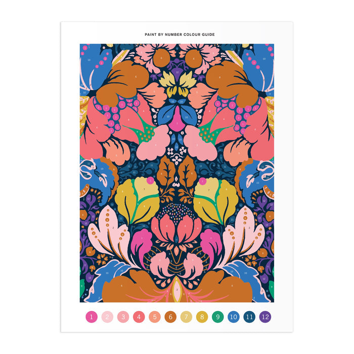 The Liberty London Liberty 9 x 12 Paint by Number Kit Glastonbury features a vibrant, symmetrical floral pattern in pink, blue, orange, yellow, and green with a paint-by-number color guide (1–12) along the bottom for acrylic paints.