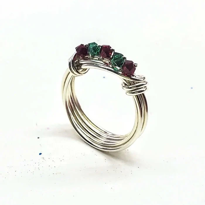 Limited edition 2026 silver wire wrapped Christmas ring featuring Swarovski crystals in red and green.