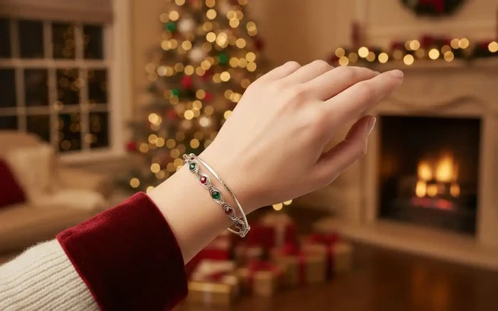 Limited Edition Red Green Christmas Holiday Tube Bracelet worn on a hand in a cozy holiday setting by a decorated Christmas tree.