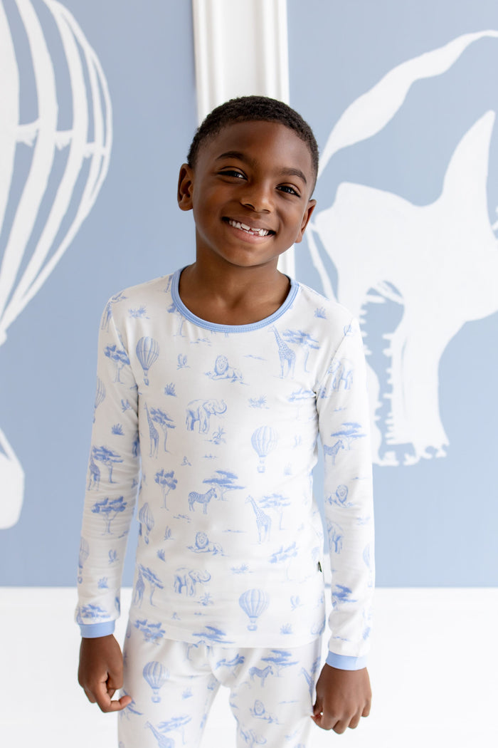Close up of smiling boy wearing the Long Sleeve Pajamas in Toile Safari