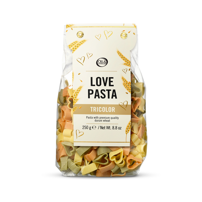 Packaged tricolor heart shaped pasta with a white label on a white background