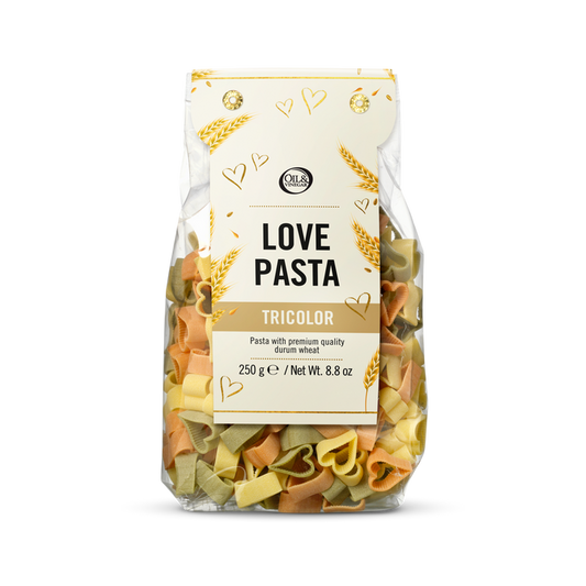 Packaged tricolor heart shaped pasta with a white label on a white background