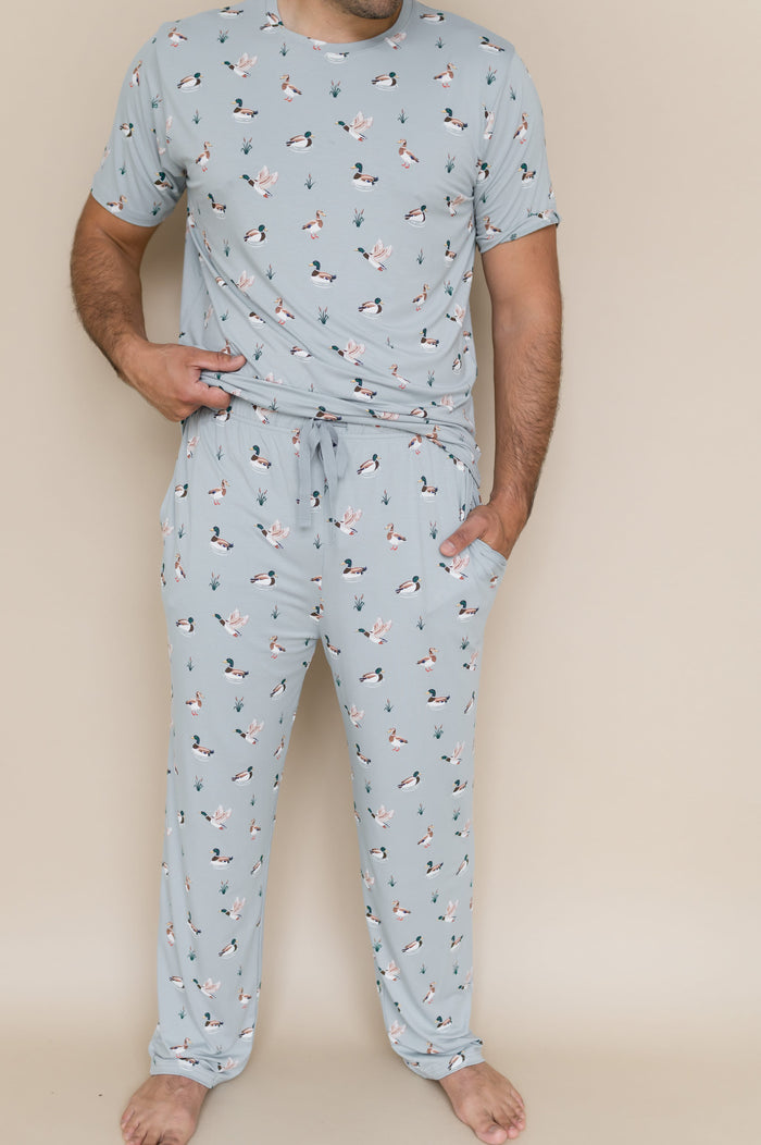 Male wearing the Men's Lounge Pants in Mallard Duck with one hand in the pants pocket and matching men's crew neck