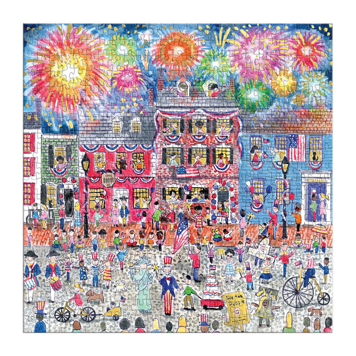 Experience vibrant Fourth of July festivities with the Michael Storrings Celebrate The USA 500 Piece Foil Puzzle, featuring fireworks, decorated houses, and crowds dressed in patriotic attire on a lively street.