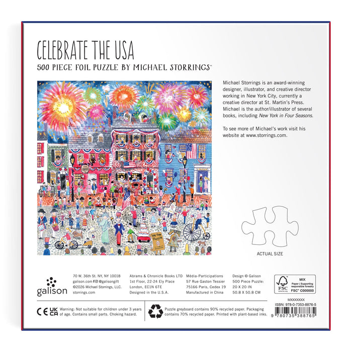 The back of the Michael Storrings Celebrate The USA 500 Piece Foil Puzzle box shows a vibrant July 4th parade with fireworks, crowds, and flags. Includes puzzle title, artist Michael Storrings info, brand details, and an actual-size puzzle piece.