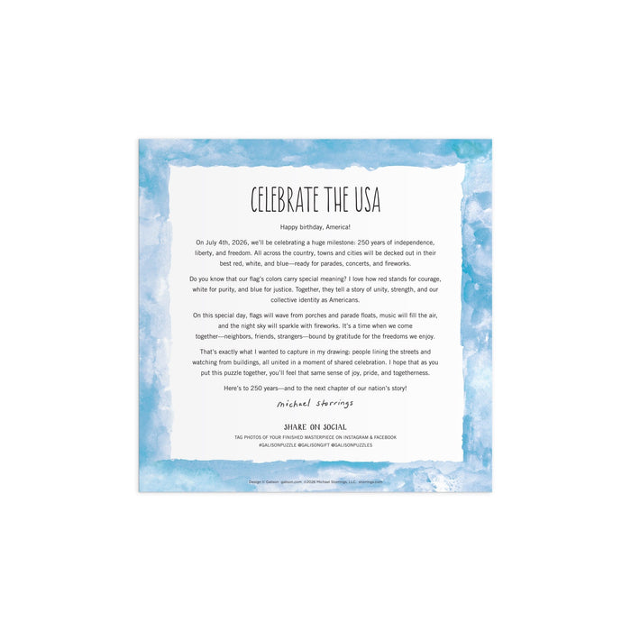 A square white page with a blue watercolor border features "Michael Storrings Celebrate The USA 500 Piece Foil Puzzle" by Michael Storrings, along with a letter about America’s birthday, unity, and hope, signed by the artist at the bottom.