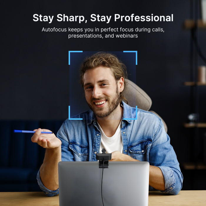 A man video chatting using a webcam with autofocus.