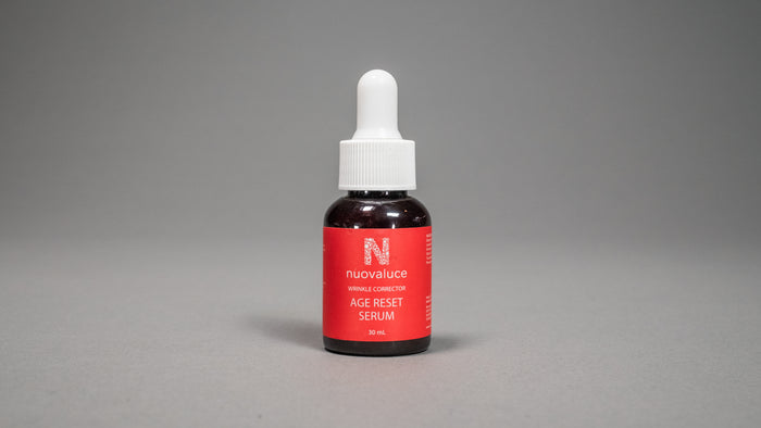 Bottle of Nuvalue Age Reset Serum on a gray background