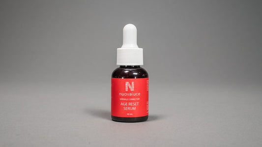 Bottle of Nuvalue Age Reset Serum on a gray background