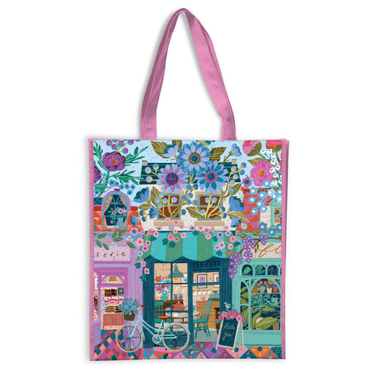 The Open For Blossoms Reusable Shopping Bag by Victoria Ball features pink handles and a vibrant illustrated flower shop with potted plants, a bicycle, and a "Hello You" chalkboard sign, full of floral and decorative details.
