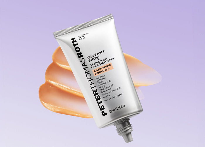 A tube of Peter Thomas Roth Hyaluve Deep Moisturizing Toothpaste floating diagonally over a peach-colored smear on a light lavender background.