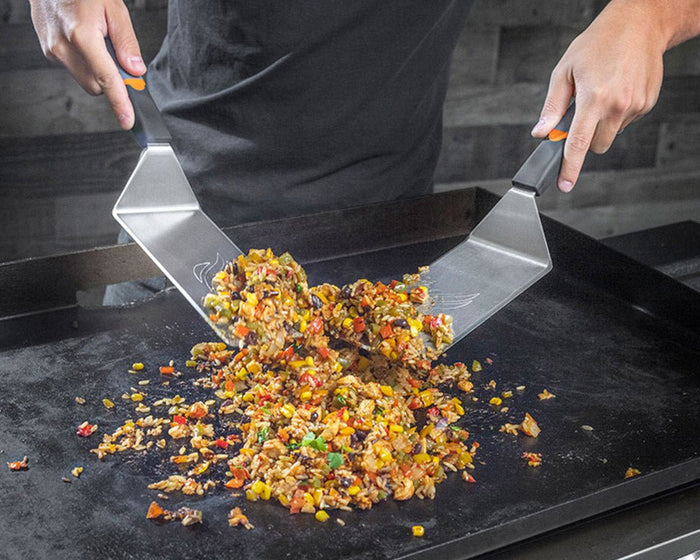 Spatulas in action mixing up some Spanish rice.