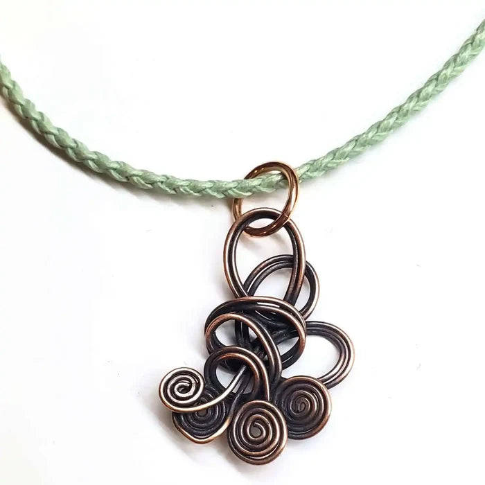 Reversible Interchangeable Copper Wire Sculpted Necklaces featuring intricate swirls and a braided cord.