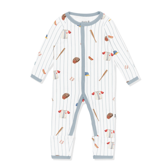 Romper in Home Run with the muted blue trim laying on a white surface