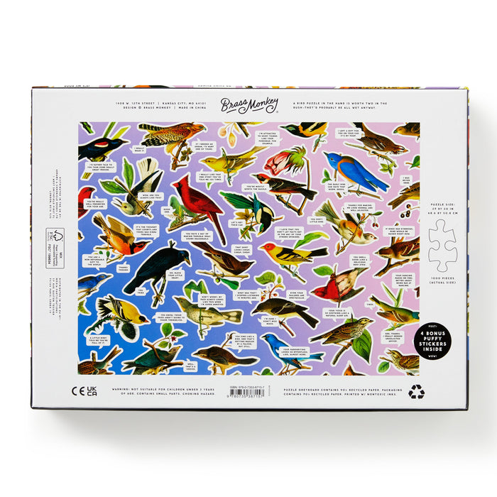 The Brass Monkey Salty Birds 1000 Piece Puzzle box features illustrated, labeled birds on a purple-pink gradient background and includes round and bonus stickers inside.