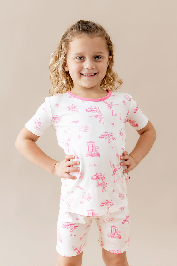 Young girl posing with both hands on her hips wearing the Short Sleeve Pajamas in Toile Ballet