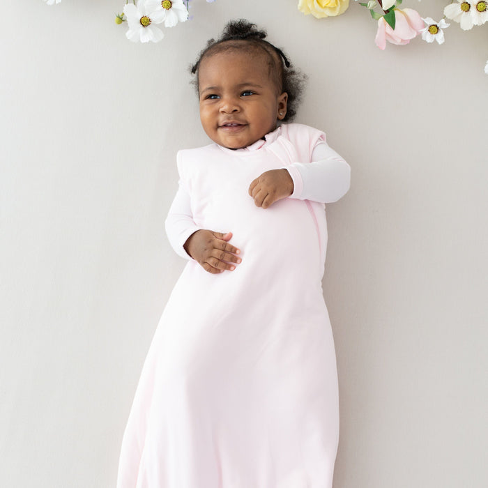 Baby wearing Kyte Baby bamboo Sleep Bag TOG 1.0 in Sakura pink