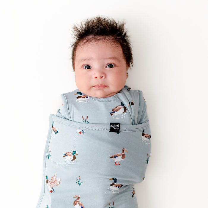 Close up of newborn swaddled in the Sleep Bag Swaddler in Mallard Duck 0.5