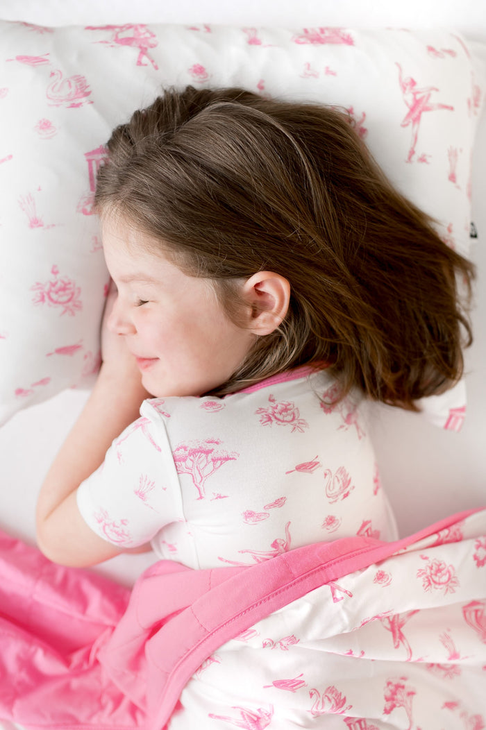 Young girl laying on a Standard Pillowcase in Toile Ballet